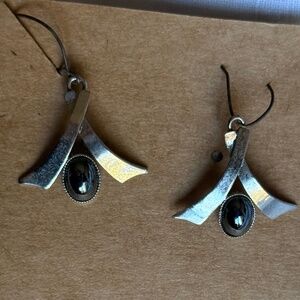 Silver dangly earrings with black stone like a cancer ribbon